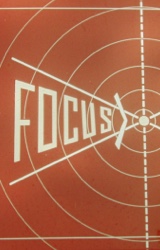 A frame from a 1969 Coca Cola filmstrip, where the word FOCUS narrows toward the center of a series of white concentric rings crossed by radiating white lines.